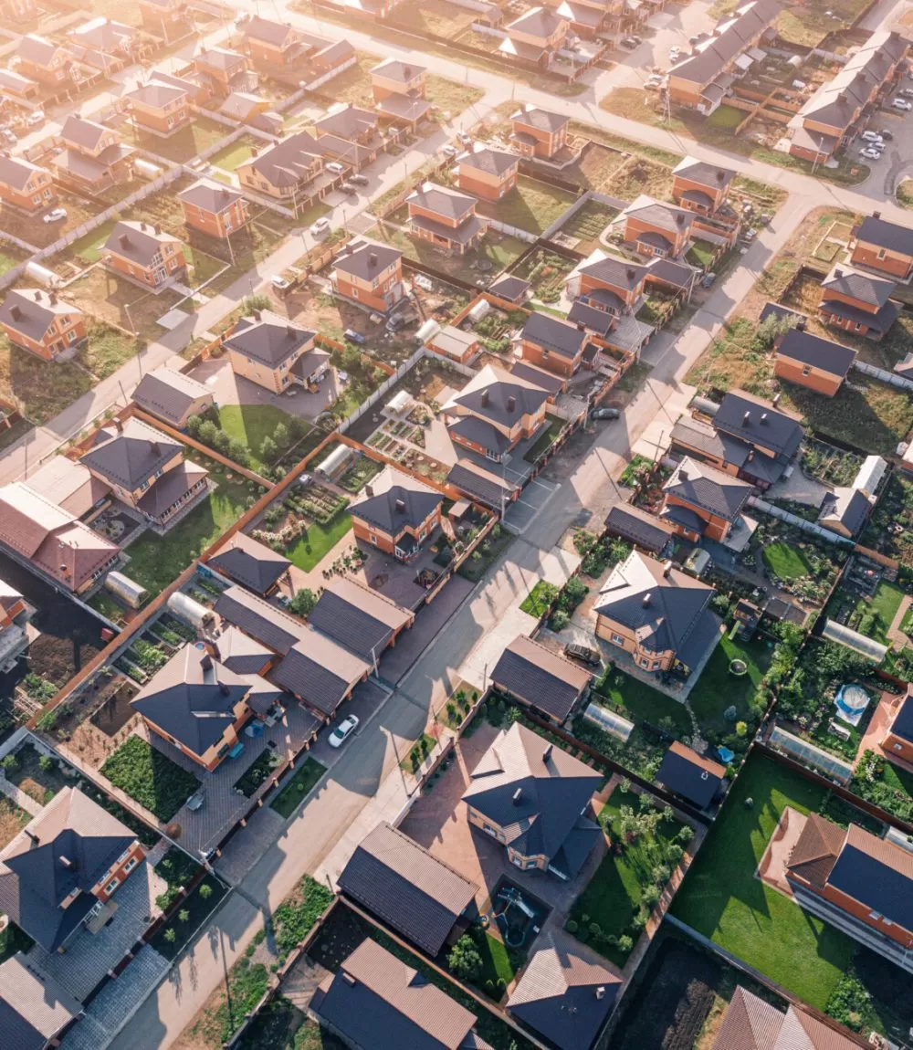 Aerial view of a luxurious village with smooth rows of two-storey duplex houses. Neighborhood in the area and real estate investments. Aerial view of a luxurious village with smooth rows of two-storey duplex houses. Neighborhood in the area and real estate investments.